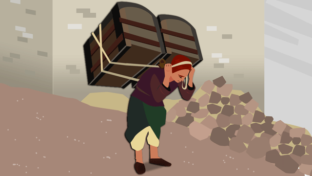 重い荷物を運んでいるポーター