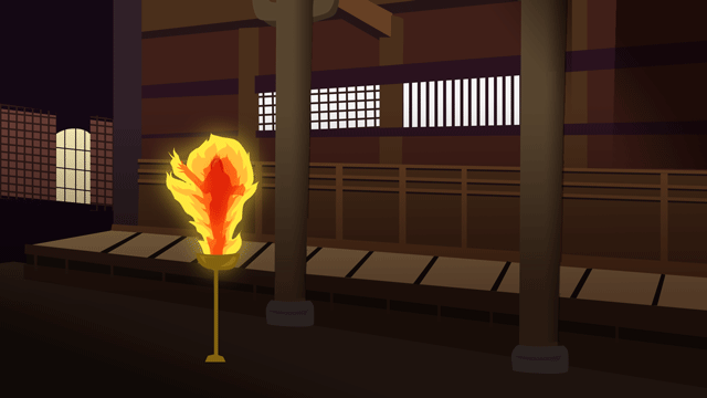 古い寺院の左側にある人間の身体のような形状の燃えているランプ