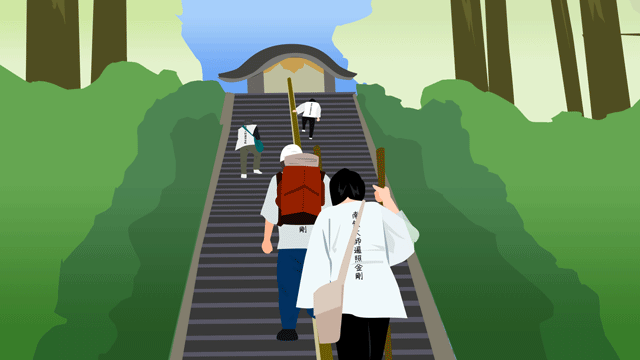 山の神殿へとつながる急な階段を登っている巡礼者